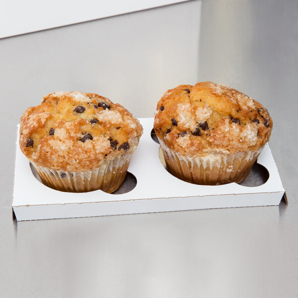 A white Baker's Mark box holding two muffins.