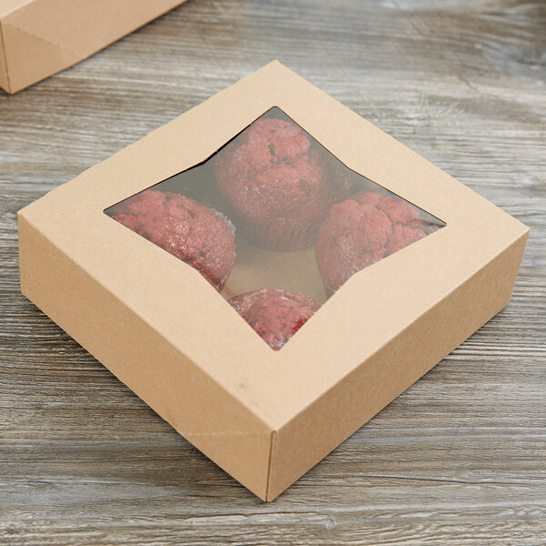 A Kraft bakery box with a window and two red muffins inside.