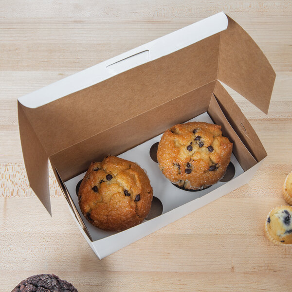 A white jumbo cupcake box with a muffin inside and a chocolate chip muffin on top.