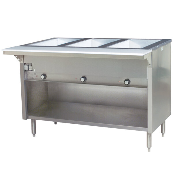 An Eagle Group stainless steel natural gas steam table with an enclosed base holding three trays of food.