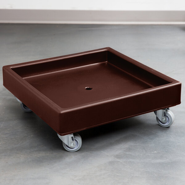 A dark brown plastic square with wheels.