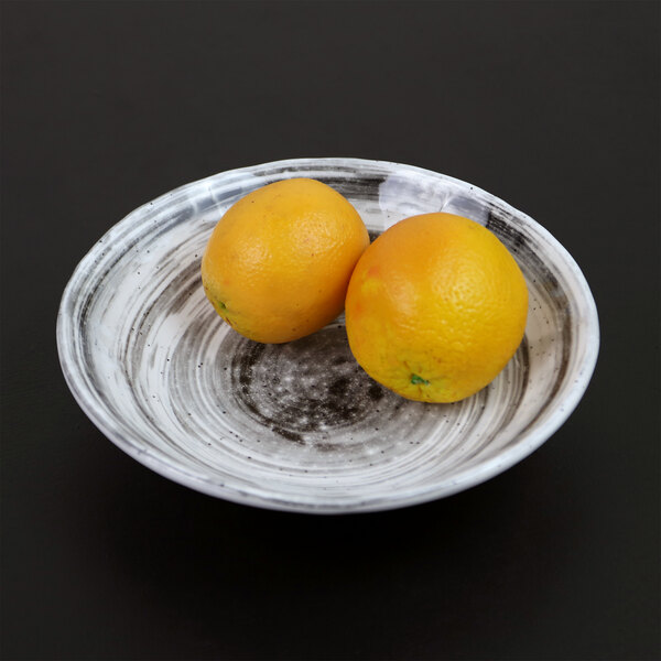 Two oranges in a black Van Gogh melamine bowl.