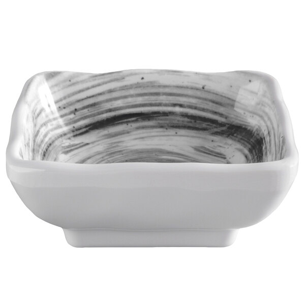 A white square bowl with black and white stripes.