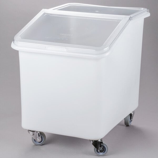 A white Cambro ingredient storage bin with a lid on wheels.