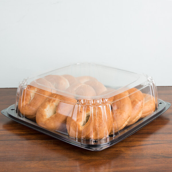A plastic Sabert UltraStack deli container with bagels inside.
