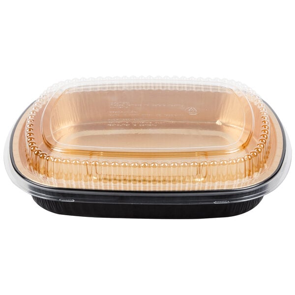 A Durable Packaging black and gold aluminum foil container with a clear plastic lid.