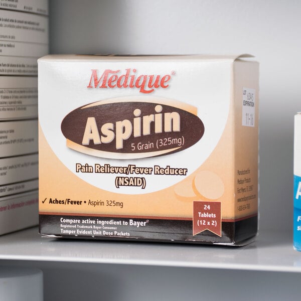 A box of Medique aspirin tablets on a shelf next to medicine.