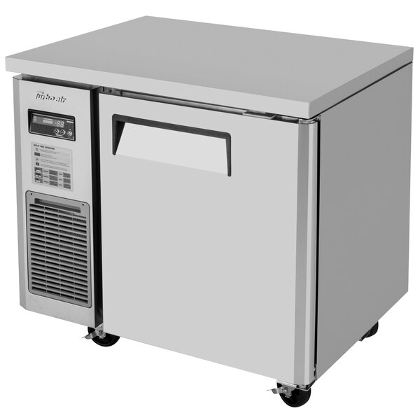 A white Turbo Air undercounter freezer with a door.
