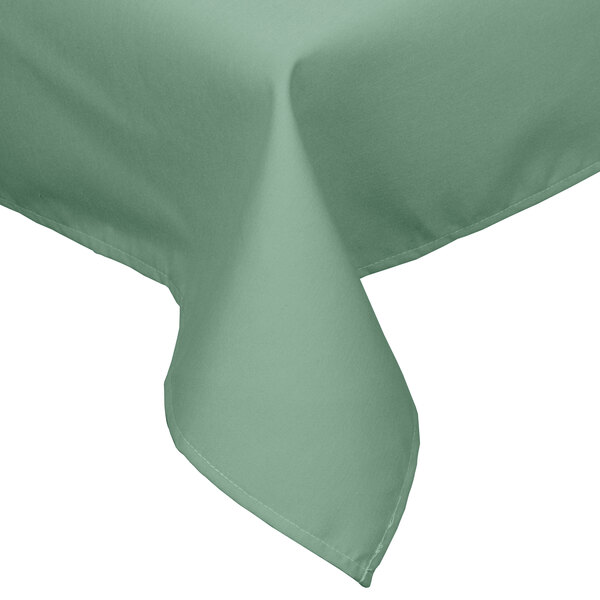 A seafoam green rectangular tablecloth with a folded edge on a table.