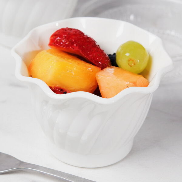 A bowl of fruit in a white Cambro swirl bowl.