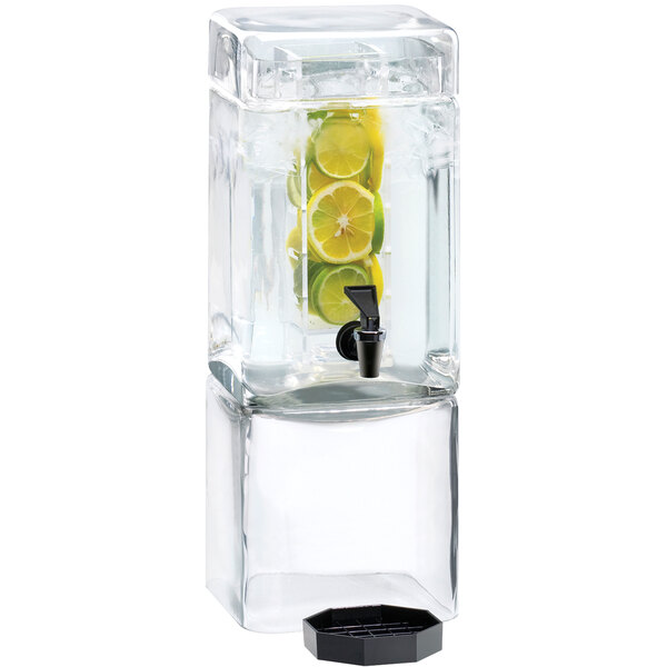 A Cal-Mil square glass beverage dispenser with lemon and lime inside.