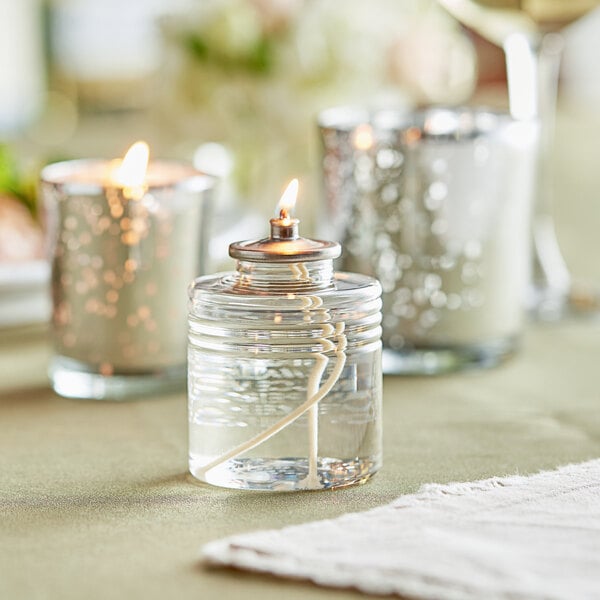 A Leola Candle clear liquid fuel cartridge in a glass candle holder.