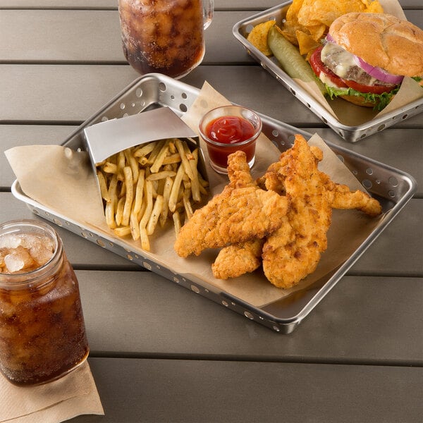 A Tablecraft stainless steel serving tray with a burger, potato chips, and a drink on a table.