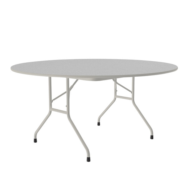A round gray granite folding table with gray legs.