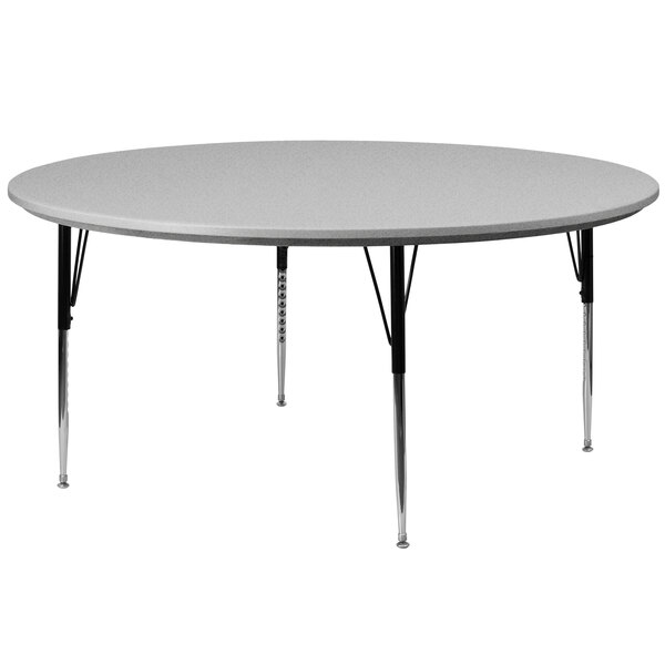 A Correll round gray granite activity table with adjustable metal legs.