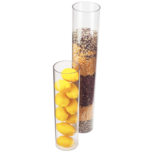 A group of lemons and seeds in two tall clear glass vases.