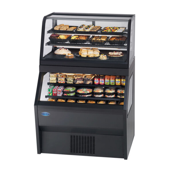 A black Federal Industries refrigerated dual service display case with food on shelves.