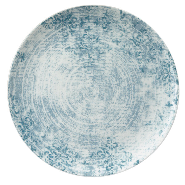 A Schonwald round porcelain coupe plate with blue and white ornaments on a blue background.