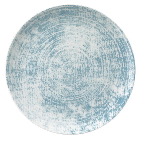 A close-up of a Schonwald blue and white porcelain coupe plate.