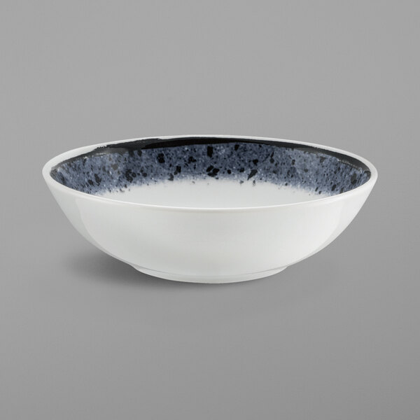 A white Schonwald porcelain bowl with a black speckled rim.