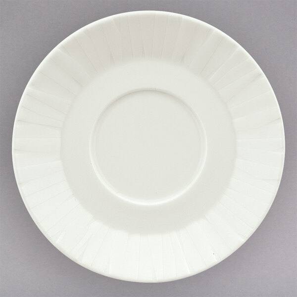 A white Schonwald porcelain saucer with a pattern on the rim.