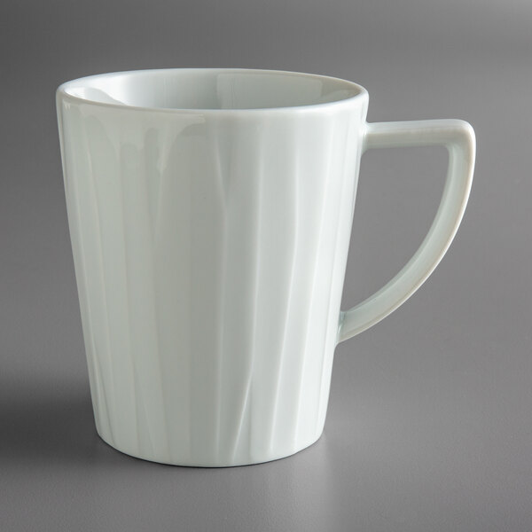 A white Schonwald porcelain mug with a handle.