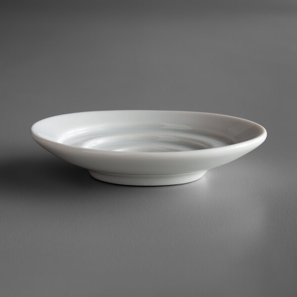 A white oval porcelain dish with a small ripple in the surface.
