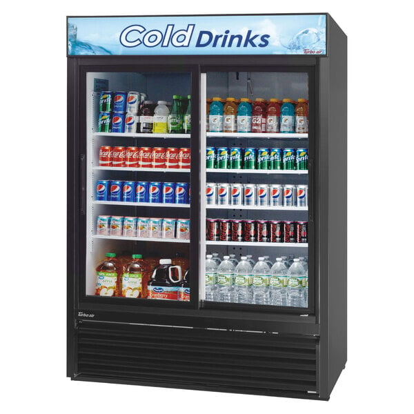 A black Turbo Air refrigerated glass door merchandiser full of soda and water.