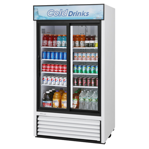 A Turbo Air white refrigerated glass door merchandiser filled with drinks and beverages.