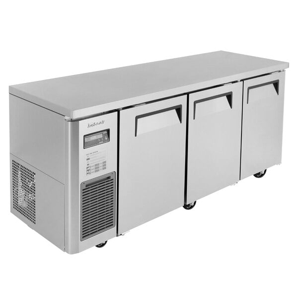 A stainless steel Turbo Air undercounter refrigerator with three doors.