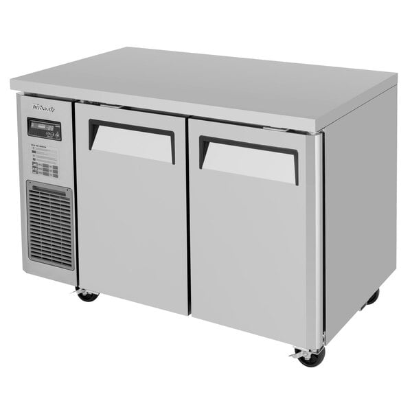 A white Turbo Air undercounter refrigerator with two doors.