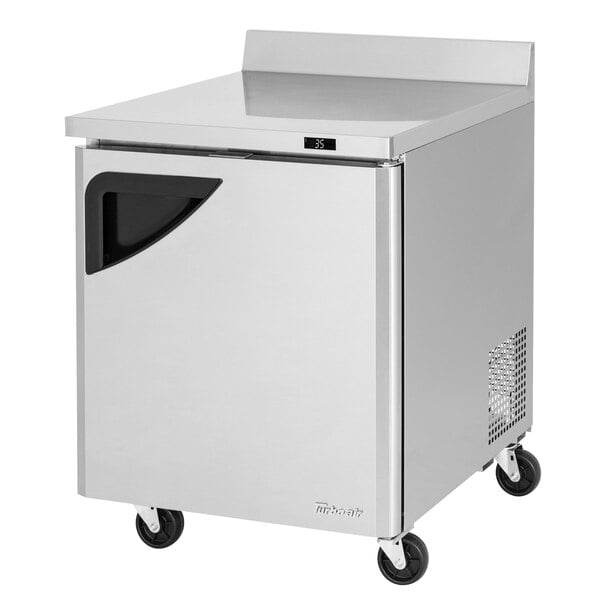 A silver Turbo Air worktop refrigerator with wheels.
