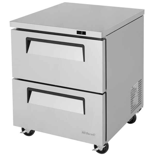 A stainless steel Turbo Air undercounter freezer with two drawers on wheels.