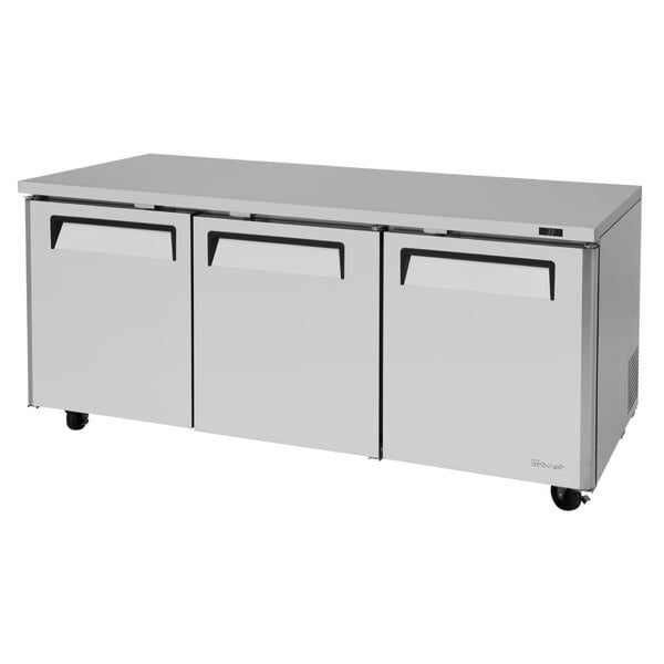 A white Turbo Air undercounter refrigerator with three drawers.
