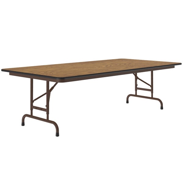 A rectangular Correll medium oak folding table with a metal frame.