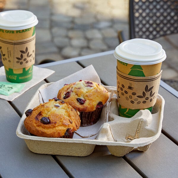 A tray of coffee and muffins on a table with a EcoChoice 2-cup carrier filled with coffee and a muffin.