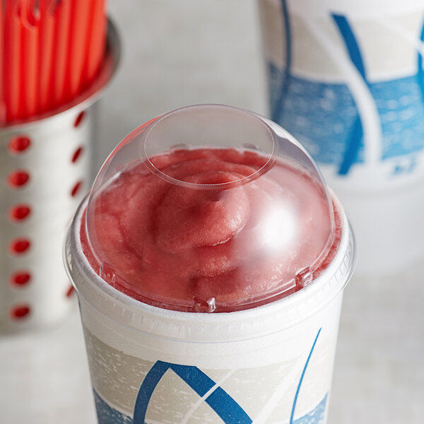 A frozen yogurt in a Dart clear dome lid with a red and white swirl on top.