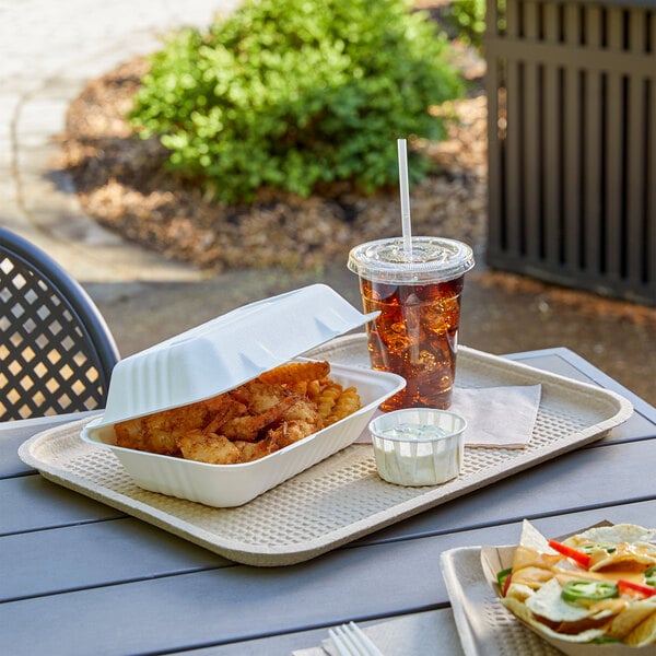 A rectangular white EcoChoice molded fiber food tray with food on it next to a drink.