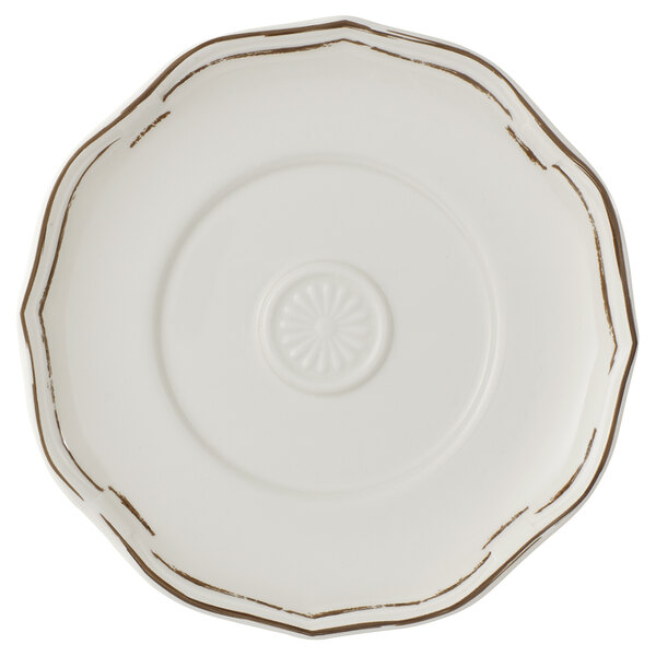 A Villeroy & Boch white porcelain saucer with gold trim.