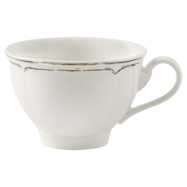 A white Villeroy & Boch porcelain tea cup with a small rim and brown trim on the handle.