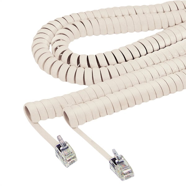 A beige Softalk coiled phone handset cord with two plugs.