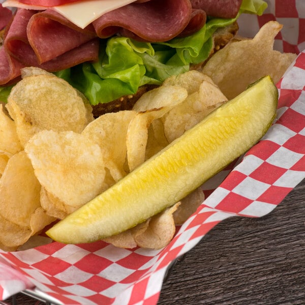 A sandwich with Nathan's Famous New York Kosher Pickle Spears and potato chips.