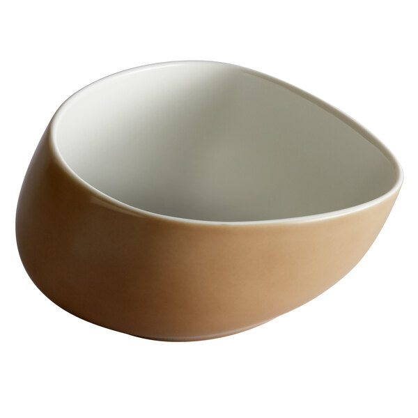 A beige porcelain bowl with a white rim and brown base.