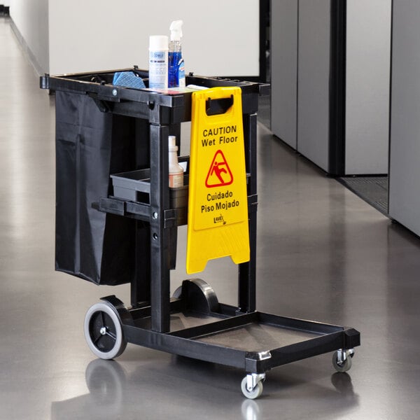 A Lavex black cleaning cart with a yellow sign on it.