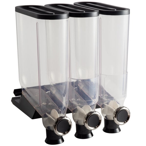 A clear plastic container with three clear plastic canisters with black caps on a black shelf.