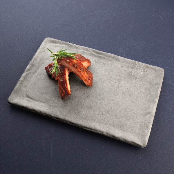 A Santiago silverstone rectangular melamine tray with ribs and rosemary on it.