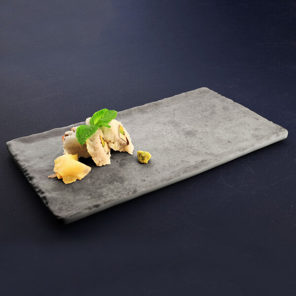A rectangular Elite Global Solutions Santiago melamine tray with food on it on a table.