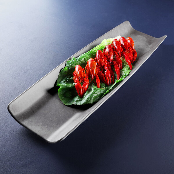 A rectangular silver melamine tray with food on it.