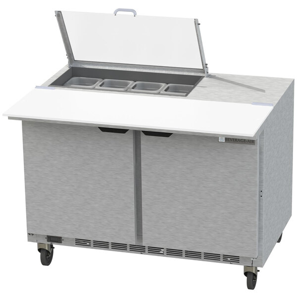 A Beverage-Air stainless steel refrigerated sandwich prep table with clear lids on a counter.