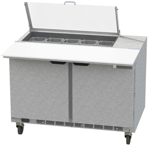 A Beverage-Air stainless steel refrigerated sandwich prep table with clear lids open over drawers.